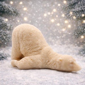 huge highly detailed polar bear shaped vegan bar soap, handmade and resting on a rustic wooden table with floral backdrop - ideal sustainable gift idea for animal lovers.