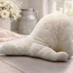 huge highly detailed polar bear shaped vegan bar soap, handmade and resting on a rustic wooden table with floral backdrop - ideal sustainable gift idea for animal lovers.