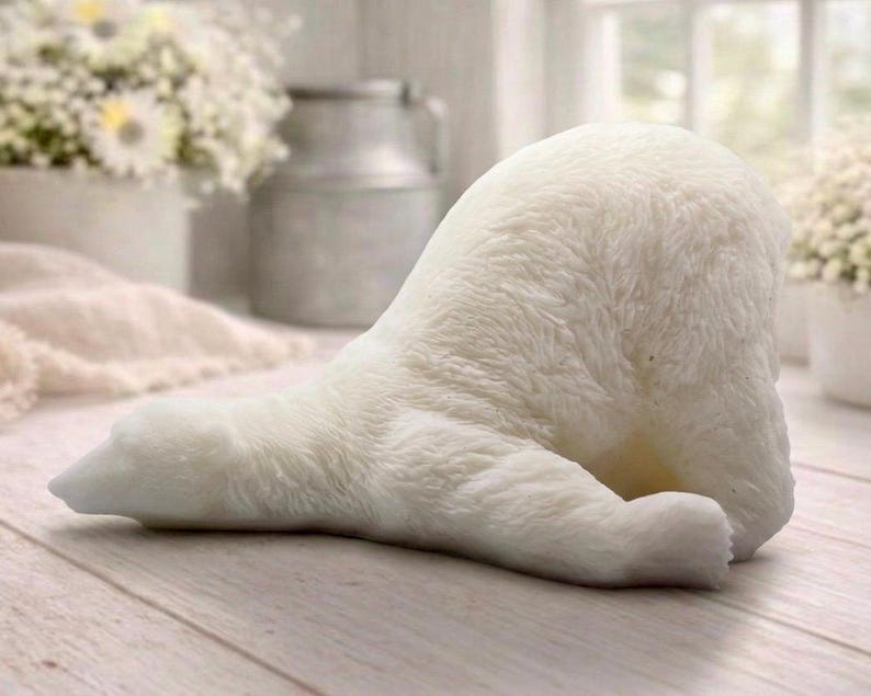 huge highly detailed polar bear shaped vegan bar soap, handmade and resting on a rustic wooden table with floral backdrop - ideal sustainable gift idea for animal lovers.