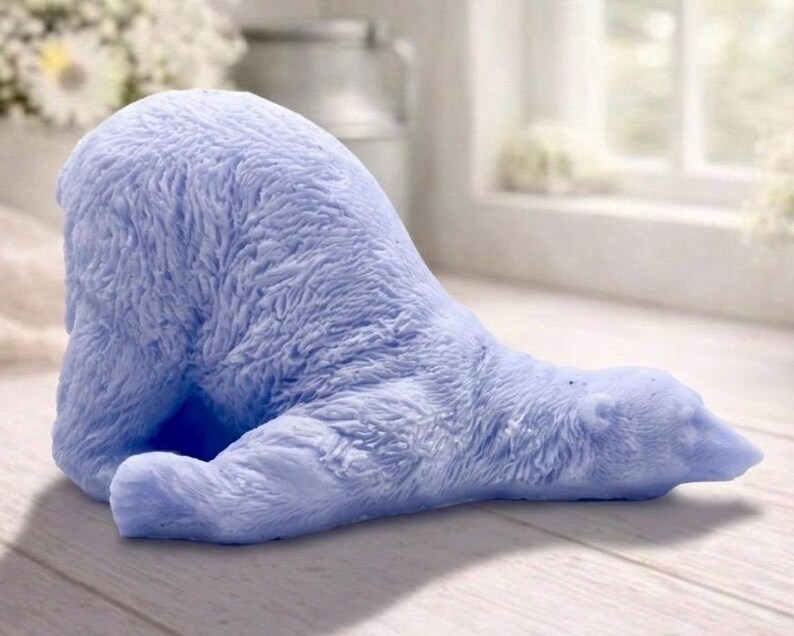 huge highly detailed polar bear shaped vegan bar soap, handmade and resting on a rustic wooden table with floral backdrop - ideal sustainable gift idea for animal lovers.