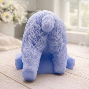 huge highly detailed polar bear shaped vegan bar soap, handmade and resting on a rustic wooden table with floral backdrop - ideal sustainable gift idea for animal lovers.