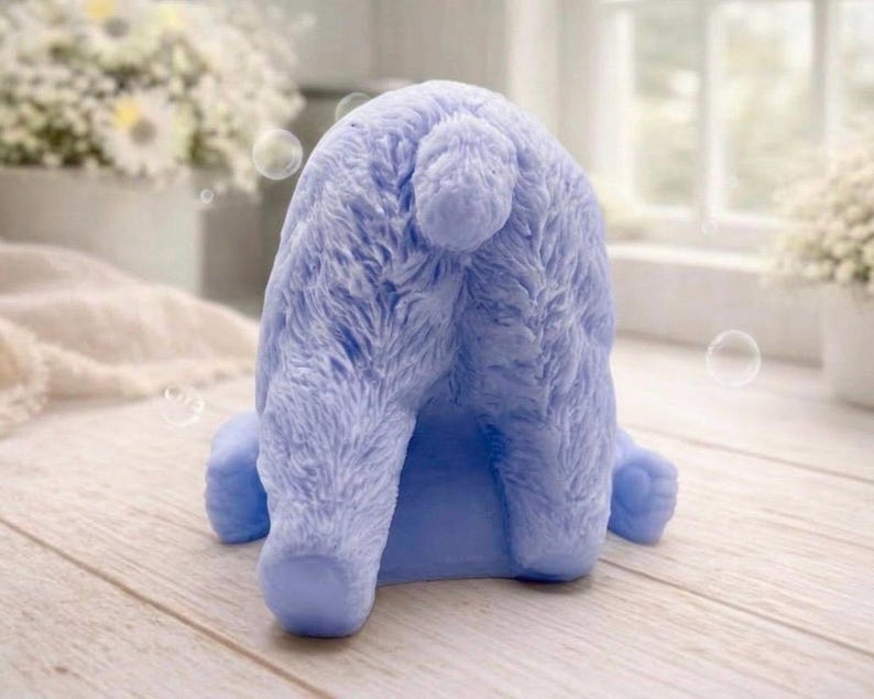 huge highly detailed polar bear shaped vegan bar soap, handmade and resting on a rustic wooden table with floral backdrop - ideal sustainable gift idea for animal lovers.