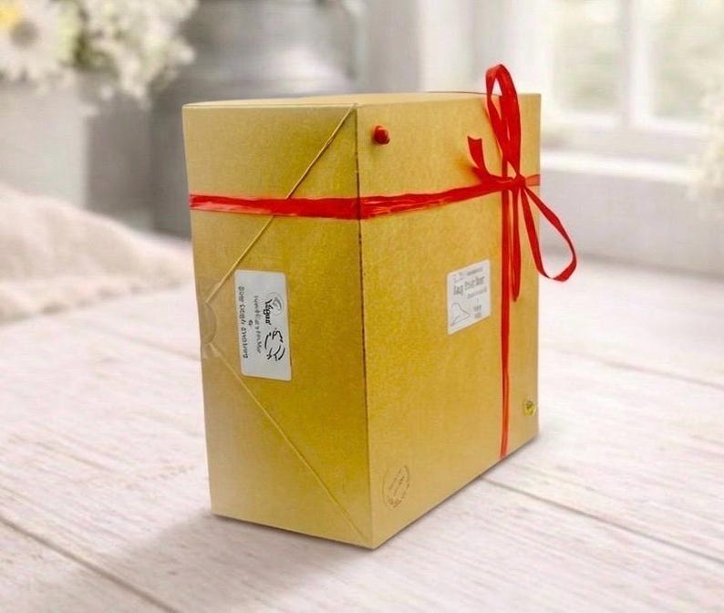 huge highly detailed polar bear shaped vegan bar soap, handmade and resting on a rustic wooden table with floral backdrop - ideal sustainable gift idea for animal lovers.