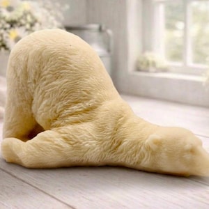 huge highly detailed polar bear shaped vegan bar soap, handmade and resting on a rustic wooden table with floral backdrop - ideal sustainable gift idea for animal lovers.