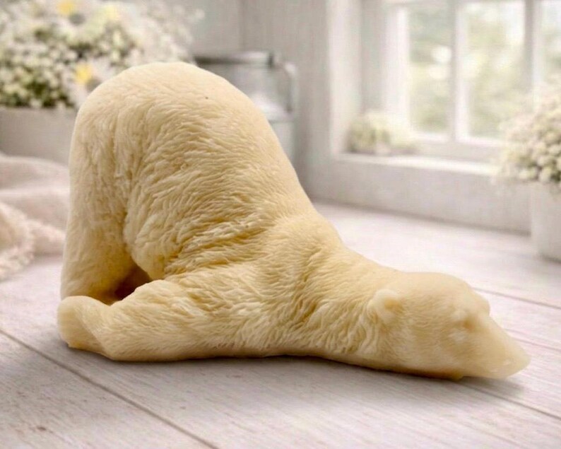 huge highly detailed polar bear shaped vegan bar soap, handmade and resting on a rustic wooden table with floral backdrop - ideal sustainable gift idea for animal lovers.