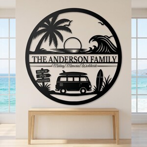 May include: A circular black metal wall art piece featuring a beach scene with a palm tree, a sun, and a wave. It includes the text THE ANDERSON FAMILY and Making Memories Worldwide, along with a van, a surfboard, and a sign reading BEACH FUN TOGETHER.