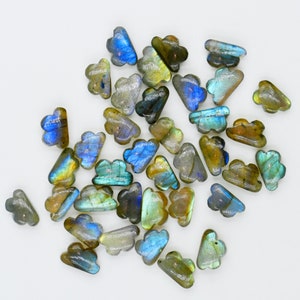 May include: A collection of iridescent labradorite gemstone cloud-shaped beads. The beads are a mix of blue, green, and gold colours.
