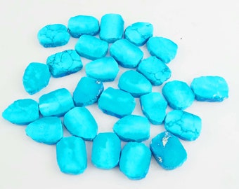 Puede incluir: Una colección de 20 cabujones de turquesa, cada uno con una forma y un tamaño únicos. Las piedras son de un color azul vibrante y tienen un acabado liso y pulido.