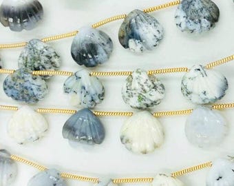 May include: A strand of white and gray gemstone beads in the shape of seashells. The beads are strung on a gold chain.