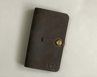 May include: A brown leather wallet with a brass button closure and the logo "COE Leather" embossed on the front.