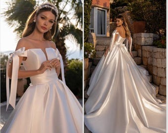 Off-shoulder wedding dress Satin bridal gown Luxury wedding dress Princess wedding gown Wedding dress with bows Long train wedding dress