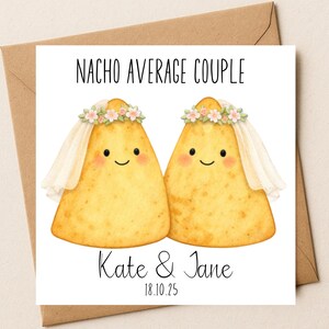 May include: A greeting card featuring two cartoon nachos with smiling faces, wearing floral crowns and veils. The text "NACHO AVERAGE COUPLE" is at the top, with "Kate & Jane" and the date "18.10.25" below. The card is inside a brown envelope.