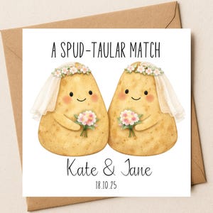 May include: A square greeting card featuring a cartoon illustration of two potatoes dressed as brides with floral crowns, veils, and bouquets. The text reads A SPUD-TAULAR MATCH, Kate & Jane, and 18.10.25. The card is placed on a brown envelope.