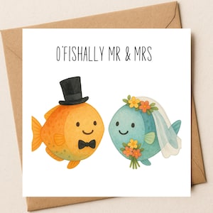 May include: A wedding card with the text "O'FISHALLY MR & MRS". The card features two cartoon fish: an orange fish wearing a black top hat and bow tie, and a blue fish with a floral crown and veil. The card is on a brown envelope.