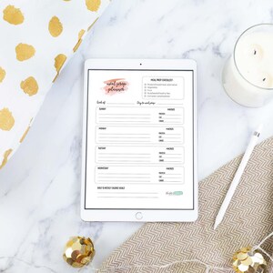 May include: A printable planner on a tablet with a pink watercolor background and the text "Social Media Planner". The planner includes a section for "Week of" and "Day to day schedule".
