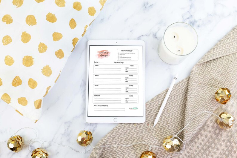 May include: A printable planner on a tablet with a pink watercolor background and the text "Social Media Planner". The planner includes a section for "Week of" and "Day to day schedule".