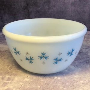 May include: White mixing bowl with a blue and black starburst pattern.