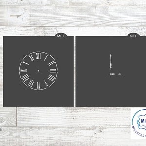 May include: Two cookie cutters, one shaped like a clock face with Roman numerals and the other shaped like clock hands. The cookie cutters are black and white and have the text "MCC" on them.