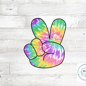 May include: A tie-dye peace sign cookie cutter with a black outline. The peace sign is in a cartoon style with a swirl pattern.