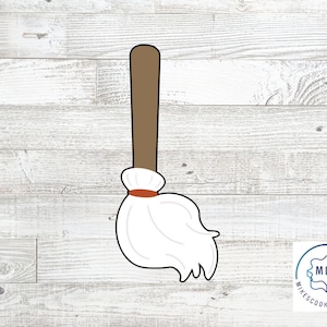 May include: A white and brown cookie cutter shaped like a mop with a brown handle and a white fluffy head.