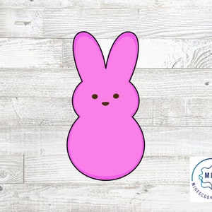 May include: Pink bunny-shaped cookie cutter with a simple face.