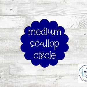 May include: A blue scalloped circle cookie cutter with the text "medium scallop circle" in white. The cookie cutter is on a white wood background. The logo "MCC Mike's Cookie Cutters" is in the bottom right corner.