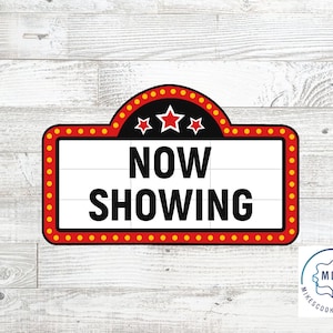 May include: Red and yellow marquee sign with white background and black text that reads "NOW SHOWING". There are three red stars on the top of the sign.