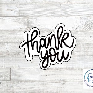 May include: Black and white cookie cutter with the words "Thank you" in a handwritten style.
