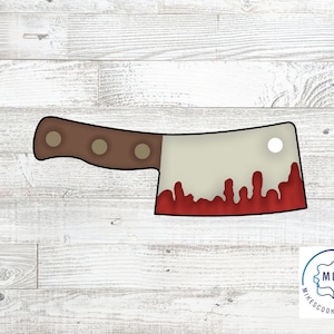 May include: A cookie cutter shaped like a bloody butcher knife. The knife has a brown handle with three rivets and a white blade with red dripping blood.