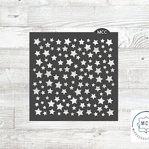 May include: A black stencil with a repeating pattern of white stars. The stencil is labeled "MCC" in the top right corner.