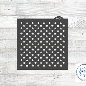 May include: A dark gray stencil featuring a pattern of white stars. The stencil is square-shaped with rounded corners and the text "MCC" at the top. The logo for "MikesCookieCutters" is in the bottom right corner.