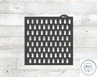 May include: A black stencil with a repeating pattern of white bunny shapes. The stencil is labeled "MCC" in the top right corner.