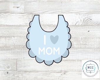 May include: A blue baby bib cookie cutter with scalloped edges and the text "I heart MOM".