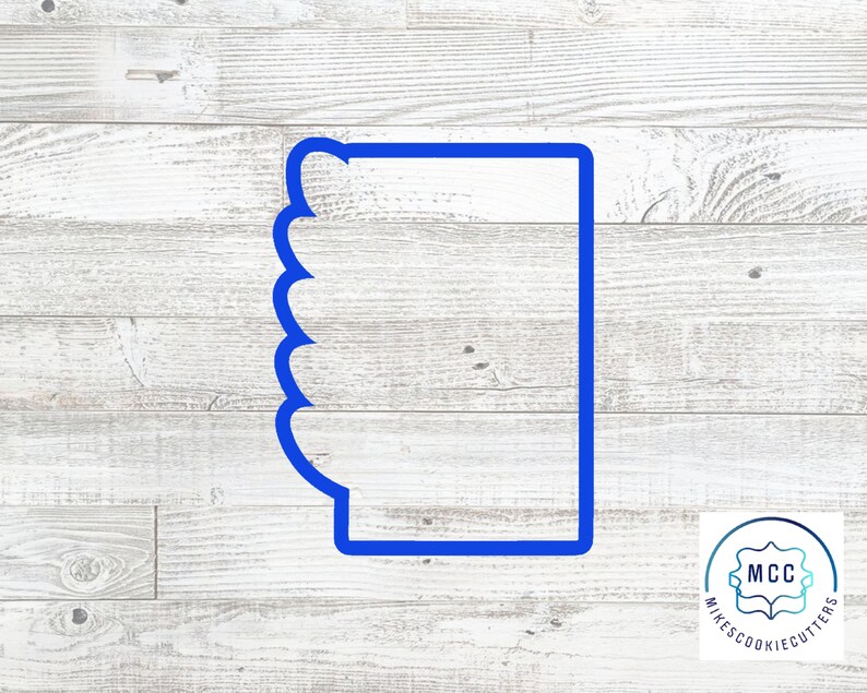 May include: Blue plastic cookie cutter shaped like a mug with a scalloped edge. The cookie cutter is on a white wood background.