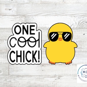 May include: A black and white cookie cutter with the text "One Cool Chick!" and a yellow chick wearing sunglasses. The chick cookie cutter is from Mike's Cookie Cutters.