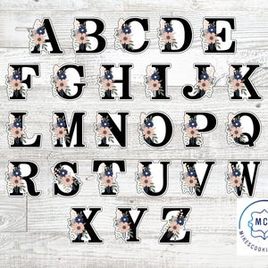 May include: A full alphabet of black letters, each adorned with a floral design in shades of pink, blue, and white. The letters are displayed on a light wood-grain background. The letters are from A to Z.