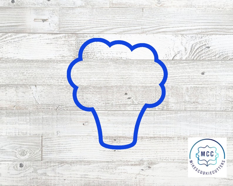 May include: Blue plastic cookie cutter shaped like a head of broccoli on a white wood background. The cookie cutter is for making cookies, fondant, or other edible crafts.