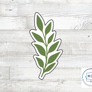 May include: Green leaf cookie cutter with a detailed design.  The cutter is made of metal and is perfect for making cookies, fondant, or other edible decorations.