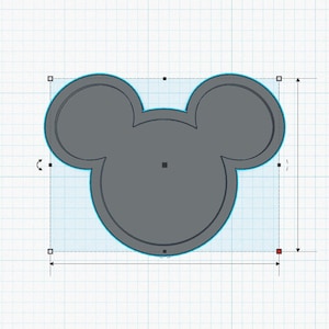 May include: A grey Mickey Mouse head shaped cookie cutter.