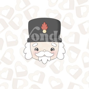 以下が含まれることがあります： 黒い帽子と白いひげを生やしたナッツクラッカーの顔の漫画イラスト。背景は白いハートの模様です。