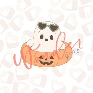 May include: A white ghost character wearing dark green heart-shaped sunglasses, sitting inside an orange pumpkin-shaped floatie with a carved jack-o'-lantern face. The background features a repeating pattern of light pink heart-shaped outlines.