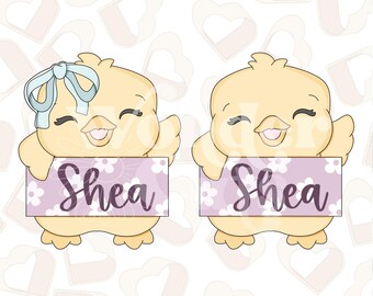May include: Two cartoon chicks holding signs that read "Shea". One chick has a light blue bow. The signs are lavender with white flowers. The chicks are yellow with smiling faces.