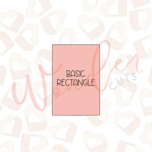 May include: A light pink rectangular cookie cutter with the words "BASIC RECTANGLE" in black. The background features a pattern of light pink heart shapes. The text "Wonder Cuts" is in the background.
