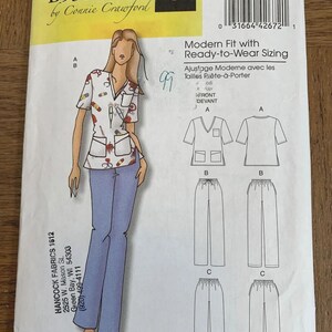 May include: Butterick sewing pattern B5301 by Connie Crawford for a scrub top and pants. The envelope features a white top with a medical-themed print, blue pants, and technical line drawings for views A, B, and C. Includes sizing for XXL-6X.