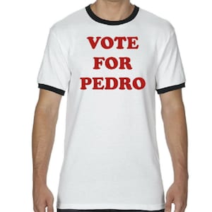 May include: White t-shirt with a black ringer neck and red text that reads "VOTE FOR PEDRO".