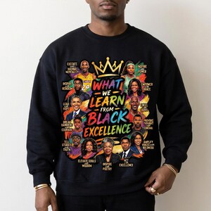 May include: Black crewneck sweatshirt with a colorful graphic. The graphic features portraits of notable figures and the text "WHAT WE LEARN FROM BLACK EXCELLENCE". The design includes a gold crown and various inspirational words.