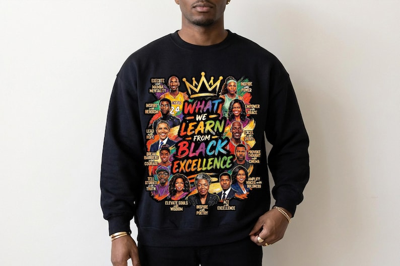 May include: Black crewneck sweatshirt with a colorful graphic. The graphic features portraits of notable figures and the text "WHAT WE LEARN FROM BLACK EXCELLENCE". The design includes a gold crown and various inspirational words.