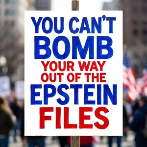 May include: A white sign with the text "YOU CAN'T BOMB YOUR WAY OUT OF THE EPSTEIN FILES" in blue and red lettering. The sign is held up in a crowd of people, with American flags visible in the background.