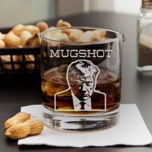 Trump Mug Shot Engraved Whiskey Glass, Funny Gift, Mugshot, Trump 2024, Mugshot Father Day, Patriotic, Republican Gift, at professional table photograph
