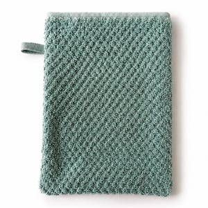 May include: A rectangular sage green washcloth featuring a textured diamond pattern across the surface. The fabric has a looped pile construction and includes a small fabric loop attached to the upper left side for convenient hanging storage.
